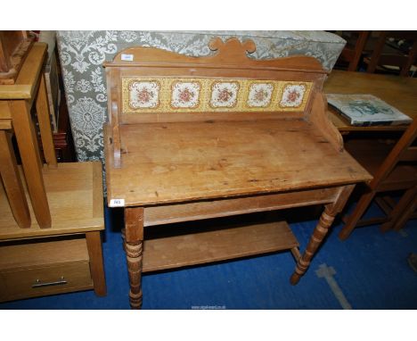 A pine Washstand with tiled back and lower shelf.