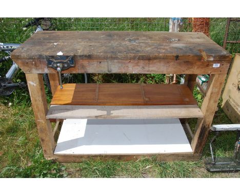 A wooden work bench with carpenters vice, 49" wide x 19" depth x 34 1/2" high.