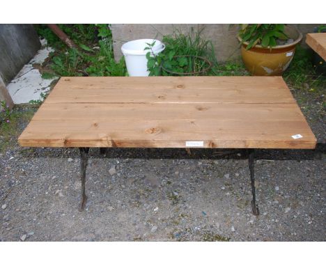 A garden bench/low table on cast iron base with hard wood plank top, 47" wide x 23" x 18" high.