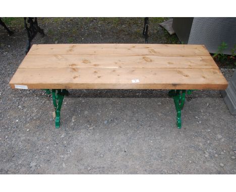 A garden bench on green painted cast iron base with hardwood plank top, 47" wide x 17" x 17" high.