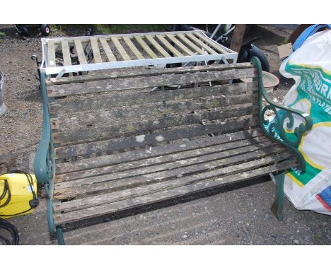 A slatted garden bench with cast iron ends, 49 1/2'' wide x 29'' high.
