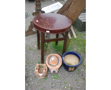 A circular plastic table, a glazed planter and a Mexican ornament, etc.