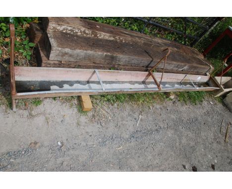 A galvanized trough with gate hooks, 9' wide.