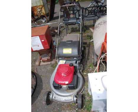 A Honda 4 stroke lawn mower with rear roller (engine starts, drive not working).