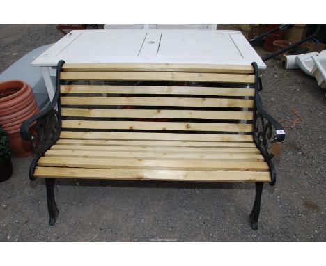 A cast iron slatted bench, 49'' wide x 29'' high.