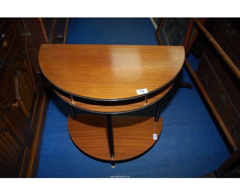 A small oval hall table with lower shelf.