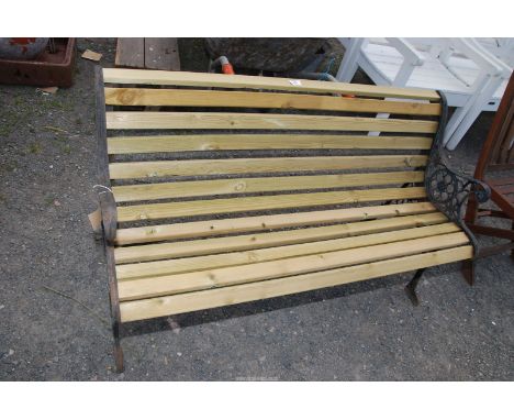 A slatted garden bench with cast iron bench ends, 48'' wide x 28'' high.