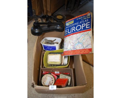 A kitchen scales, old door knobs, pulleys, brass fittings.