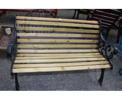 A slatted garden bench with cast iron ends, 49'' wide x 29'' wide.