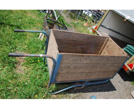A large metal framed wooden barrow with open end tail gate and pneumatic tyres, 42" x 22" x 18".
