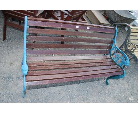 A slatted garden bench with lion head bench end, painted in blue, 49 1/2'' wide x 28 1/2'' high.