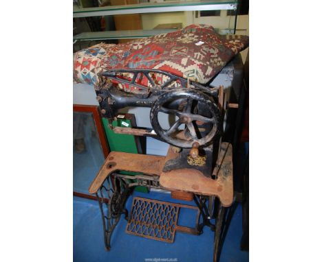 An old "Singer" foot operated sewing machine serial No 29K53, plus a tapestry (as found).