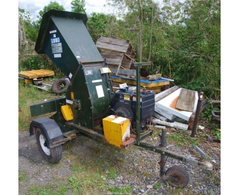 A large "Waist Whacker Junior" chipper on road type trailer chassis with 50 mm ball hitch. In working order with a Kohler ele