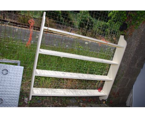 A large cream painted shelf unit, 57" wide x 55" high x 8" deep.