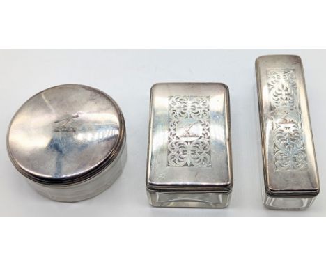 A George III set of 3 silver topped glass containers, arms with arrow family crest, hallmarked London, 1826, maker possibly G