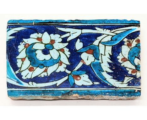 A late 16th century Ottoman Iznik border tile, 12cm x 17.5cm