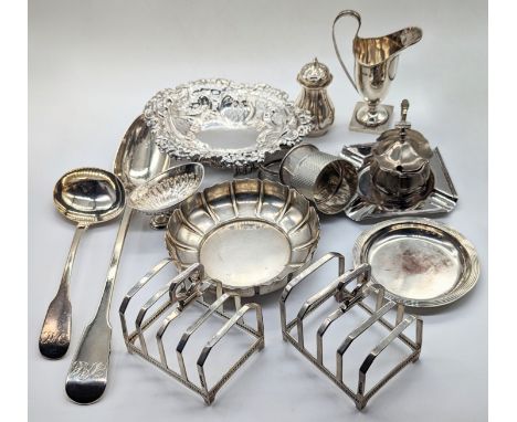 A collection of silver flatware to include a pair of Mappin &amp; Webb toast racks, a Georgian basting spoon and ladle, each 