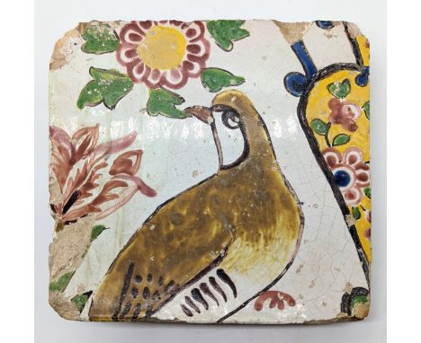 An unusual 18th century Safavid Persian glazed pottery tile depicting a partridge, 18cm x 18c