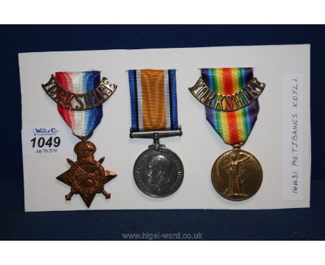 A WWI trio of Medals to; 14431 Pte. T. J. Baines, Kings Own Yorkshire Light Infantry, with two brass shoulder titles, in exce