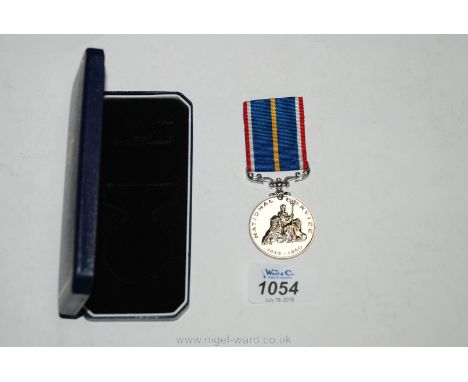 A boxed National Service medal engraved to; 23434223 CPL. Green J. V. 157-1959 R. E.