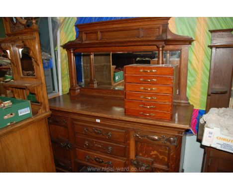 A good Arts and Crafts Oak mirrorback Sideboard having rectangular bevel plate mirror in shaped frame with shelf and turned c