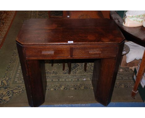 A 1940's Oak two drawer Side Table with canted corners with shelf style sides