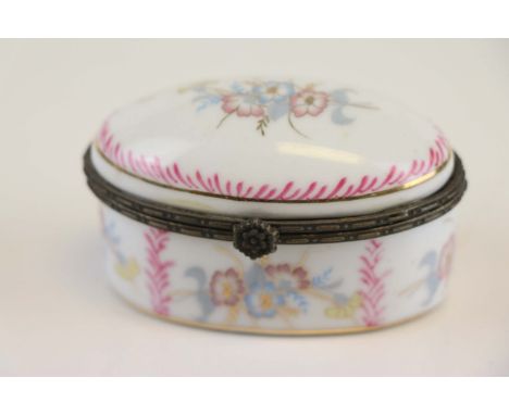An antique enamel trinket box with floral decoration. 