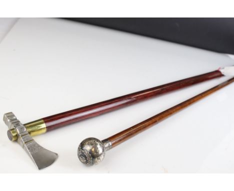 Military Swagger Stick, the silver handle with crest, together with Walking Stick with Axe Head Handle 