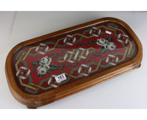 19th century Walnut Stand raised on four squat bun feet, set with a woolwork and beaded panel with glass cover, 57cms long