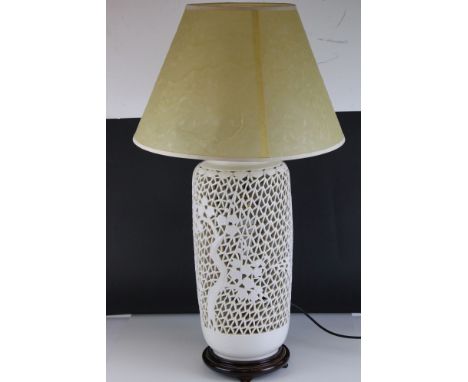 A large oriental ceramic table lamp in reticulated and baluster form, with cherry blossom decoration