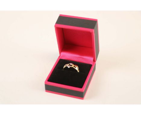 A mixed gold dolphin style ring 