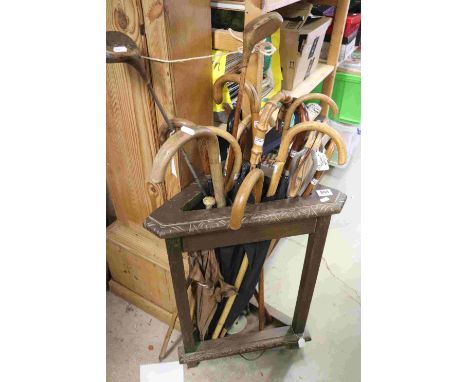 A large quantity of walking sticks, two vintage golf clubs shooting stick etc together with an antique wooden stick stand. 