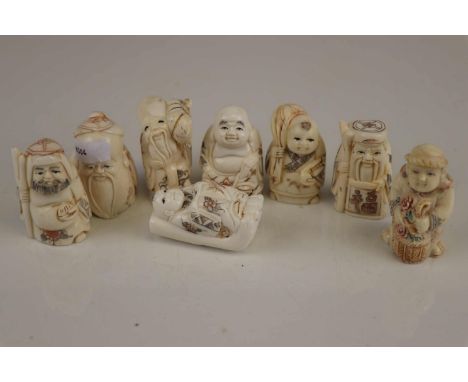 A collection of eight carved bone Japanese netsuke. 