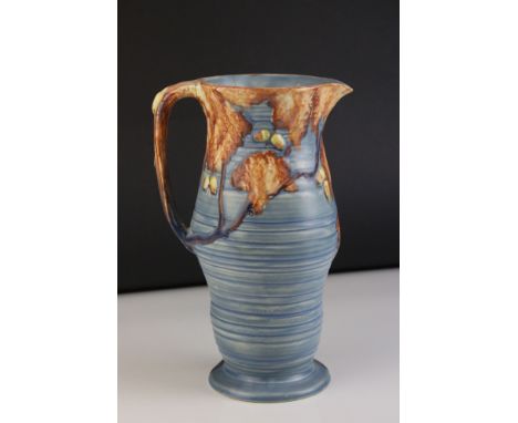 Carltonware Moulded Relief Jug, blue ground with autumnal trees decoration, 26cms high 