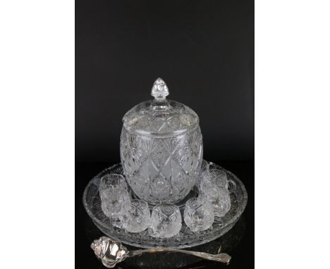 A cut glass punch set with lidded bowl and eight glasses and silver plated ladle. 