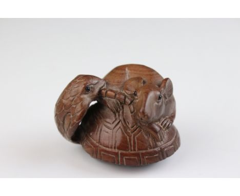 A carved wooden Japanese netsuke in the form of a snake and rat, signed to underside. 