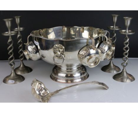 A silver plated punch bowl with cups and ladle together with four contemporary candlesticks with twisted stems. 