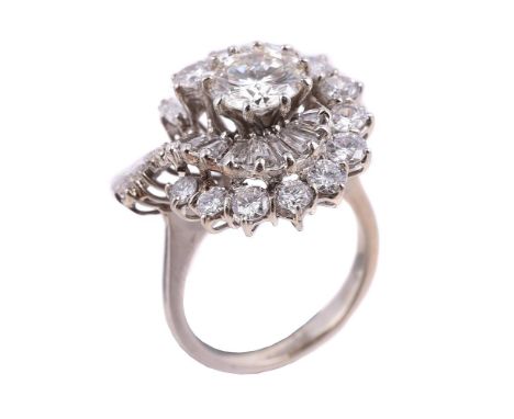 A diamond cluster dress ring, the central brilliant cut diamond weighing 1.47 carats, within a swirling surround of brilliant