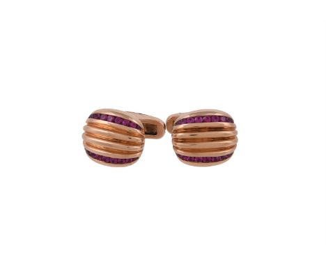 A pair of ruby cufflinks by William & Son, the reeded oval panels set with two rows of channel set graduated circular cut rub