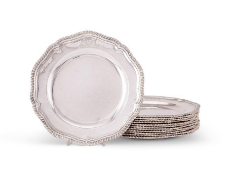 A set of twelve late George II silver shaped circular dinner plates by Edward Wakelin, London 1754, with raised gadrooned rim