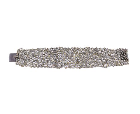 A brown and yellow diamond bracelet, the flexible cuff set with graduated brilliant cut brown and yellow diamonds, approximat