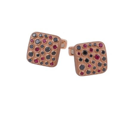 A pair of black diamond and ruby cufflinks by William & Son, the matt gold panels set with circular cut rubies and brilliant 