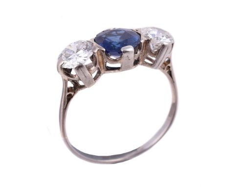 A sapphire and diamond three stone ring, the circular cut sapphire estimated to weigh 1.48 carats, flanked by two brilliant c