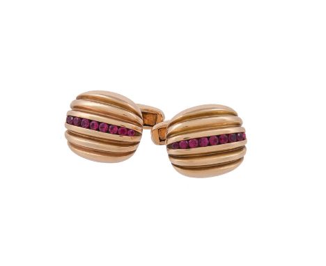 A pair of ruby cufflinks by William & Son, the cushion shaped reeded panels with a central row of channel set graduated circu