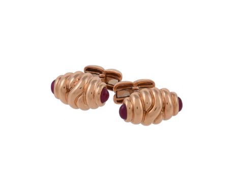 A pair of ruby cufflinks by William & Son, the reeded oval cufflinks with oval cabochon ruby terminals, 2cm wide, with swivel