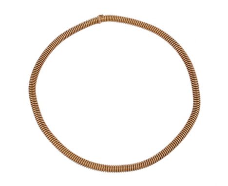 An early 20th century French gold tubogas necklace, the sprung necklace measuring 5mm diameter, to a concealed clasp, stamped