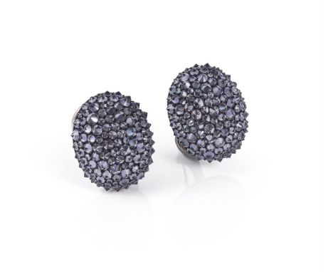 A pair of colour change garnet ear clips by Hemmerle, the domed oval panels inverted set with circular cut colour change garn