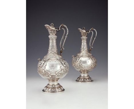 A pair of Victorian Irish silver Armada pattern claret jugs by John Smyth, Dublin 1879 and 1880, of typical form, with an ope