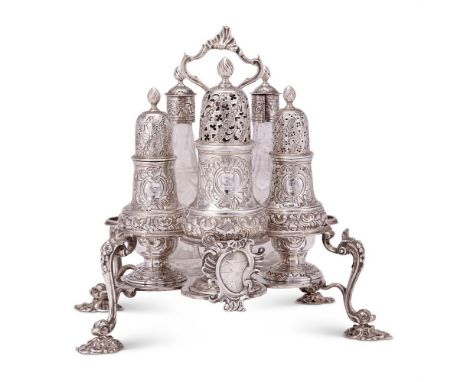 An early George III silver Warwick cruet stand by Alexander Johnston, London 1762, the shell centred handle with tongue-cappe
