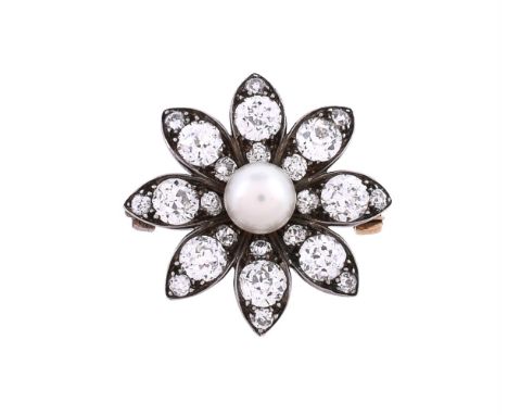 A late Victorian diamond and pearl flower head brooch, circa 1890, the petals set with graduated old brilliant cut diamonds, 